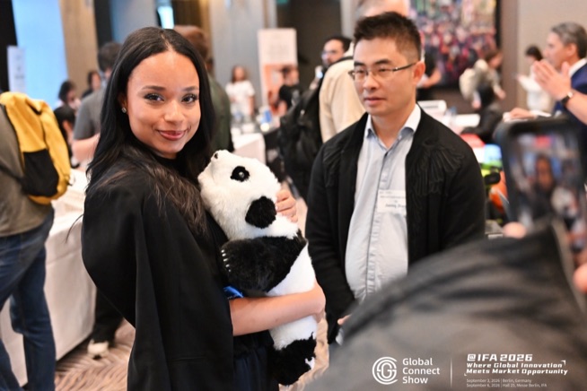 An attendee with a panda plush at a brand demo, GCS IFA 2026